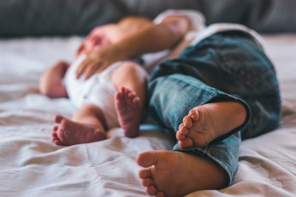Baby and toddler feet on bed