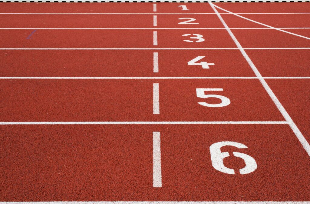 A race track with white lines and numbers one to six