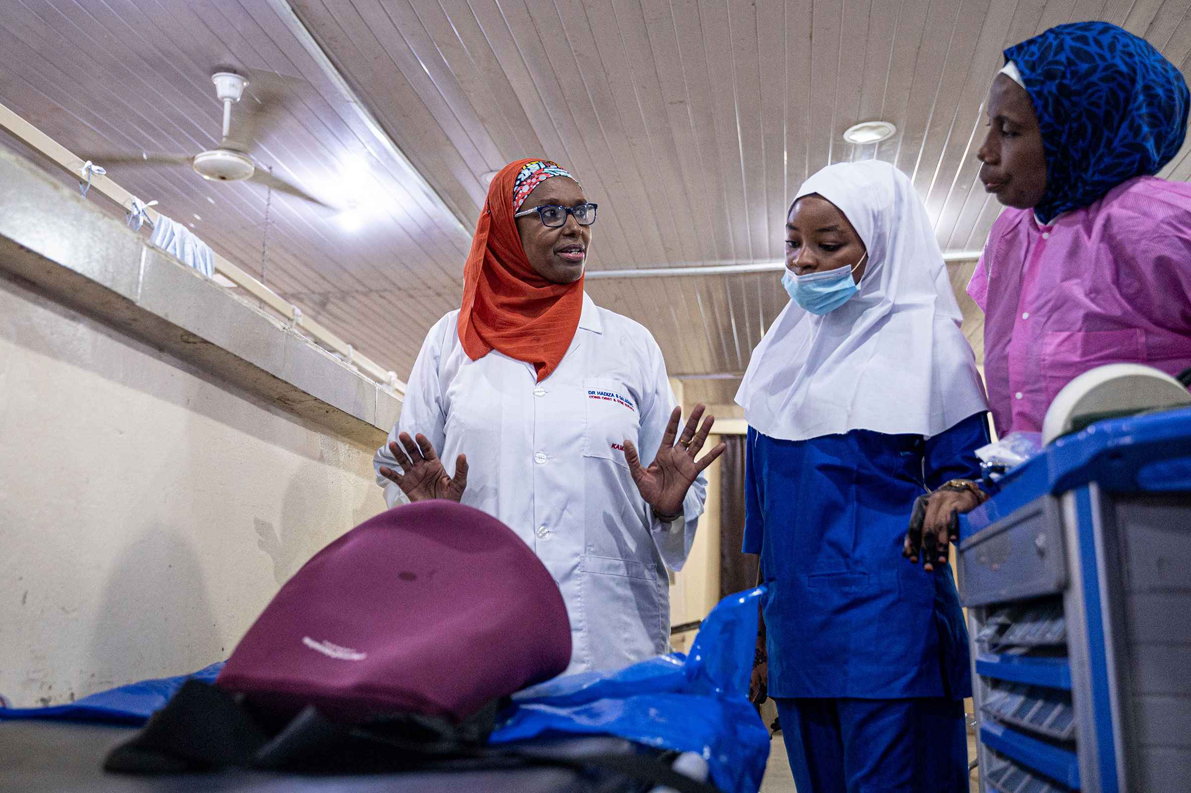 Professor Hadiza Shehu Galadanci, Director of The African Center of Excellence for Population Health and Policy (ACEPHAP), demonstrates the use of the E-MOTIVE care bundle to Fatimah Sarikin Fulani (blue PPE) and Nafisa Abbas (pink) in the E-MOVITE research site at the Aminu Kano Teaching Hospital, Bayero University, in Kano, Nigeria, on August 10, 2023. The E-MOTIVE care bundle is used to detect and prevent postpartum hemorrhaging.