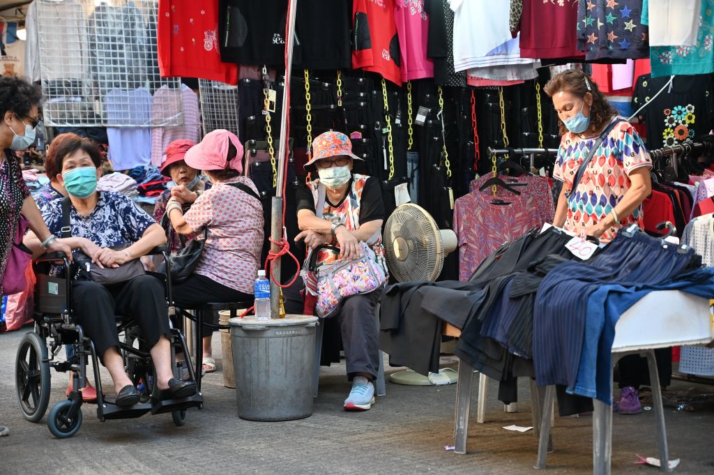Elderly women hang out in a market in Hong Kong on Sept. 25, 2022.