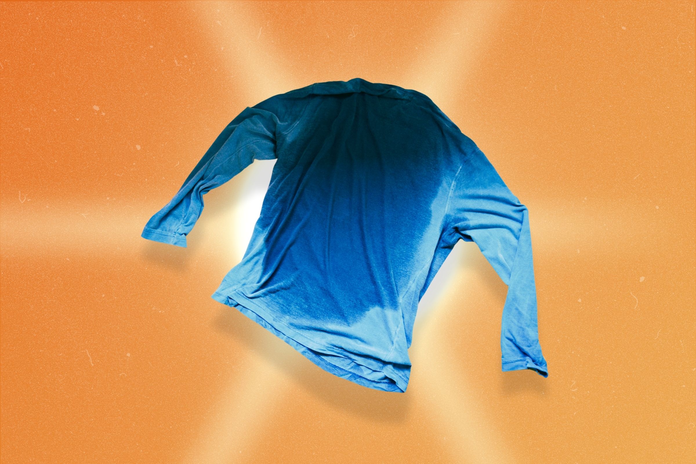 A blue long sleeve shirt with a big sweat spot on it 