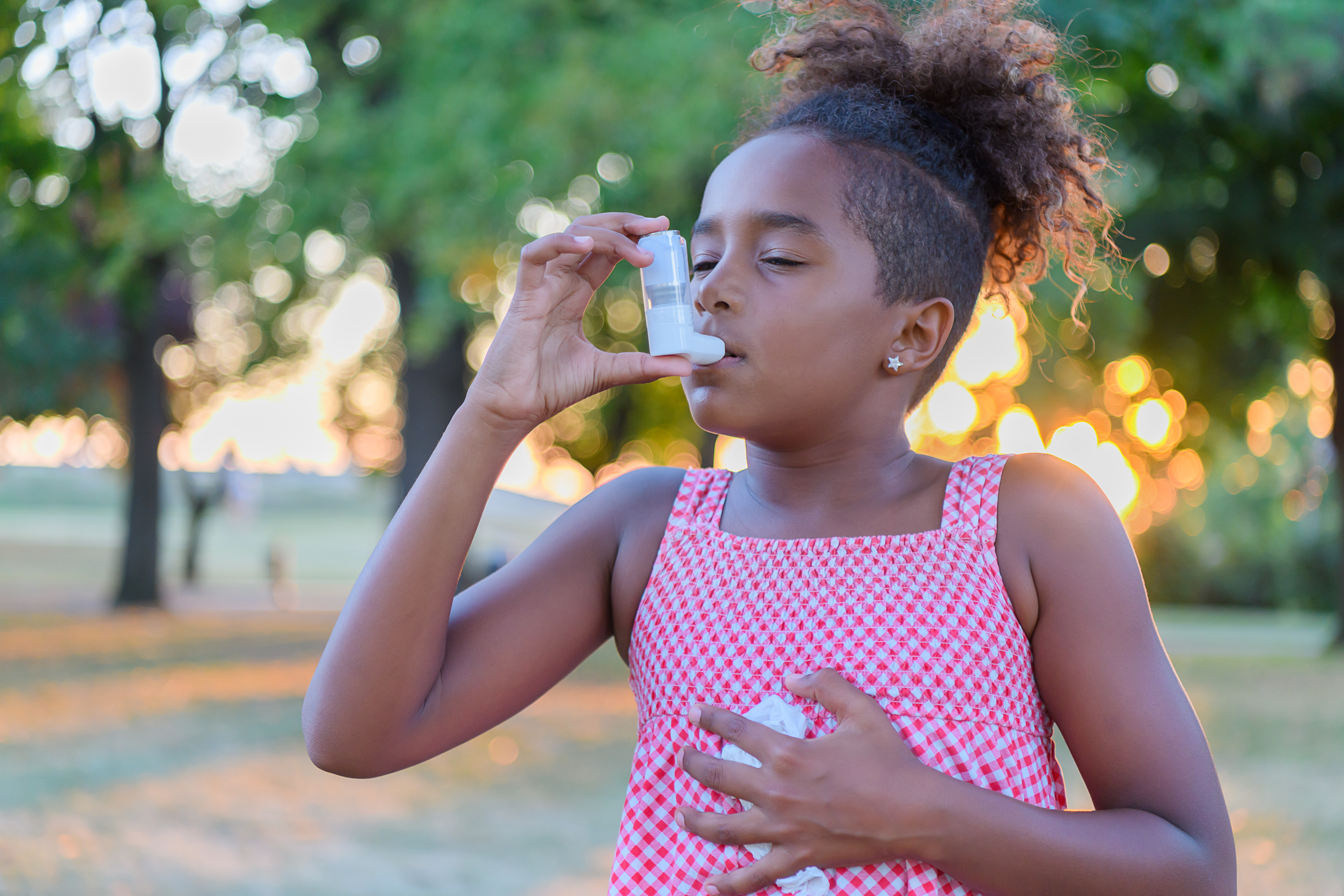 Beautiful Little African-American Girl is Having Asthmatic Problems Outside in Nature.